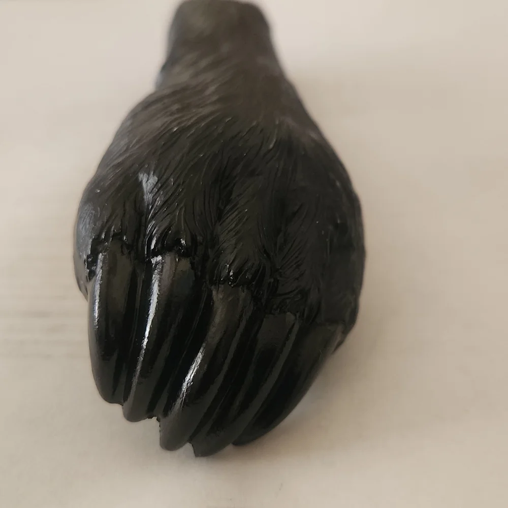 RESIN AND METAL BEAR PAW BOTTLE OPENER.